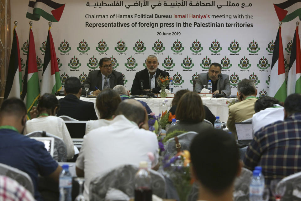 Hamas' chief Ismail Haniyeh, center, speaks during his meeting with foreign reporters at al-Mat'haf hotel in Gaza City, Thursday, June 20, 2019. Hamas' chief says Israel is ignoring the terms of an indirect cease-fire agreement for the Gaza Strip. (AP Photo/Adel Hana)