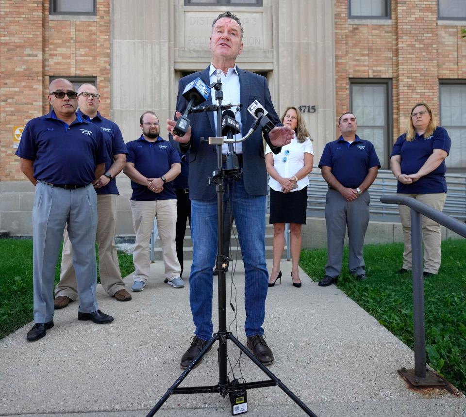 Republican gubernatorial candidate Tim Michels speaks during a news conference outside the 3rd District Police Station on Milwaukee's west side on Tuesday. Michels, who was endorsed by the Milwaukee Police Association, appeared with union officers and his wife, Barbara, pictured right of Michels, and used Milwaukee's rising homicide rate as an opportunity to bash Gov. Tony Evers.