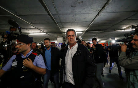 FILE PHOTO: Sacked Catalan government interior minister Joaquim Forn walks after landing at El Prat airport from Brussels, in Barcelona, Spain, October 31, 2017. REUTERS/Juan Medina