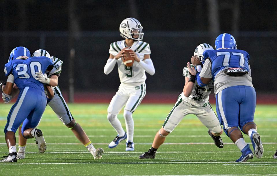 D-Y quarterback Jayden Barber looks for a receiver pressured by Mashpee.