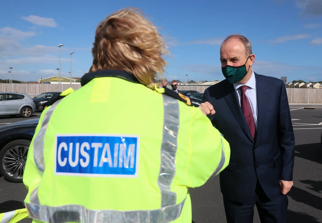 Taoiseach Micheal Martin is greeted by a customs official at Rosslare Europort, Co Wexford (Brian Lawless/PA) (PA Wire)