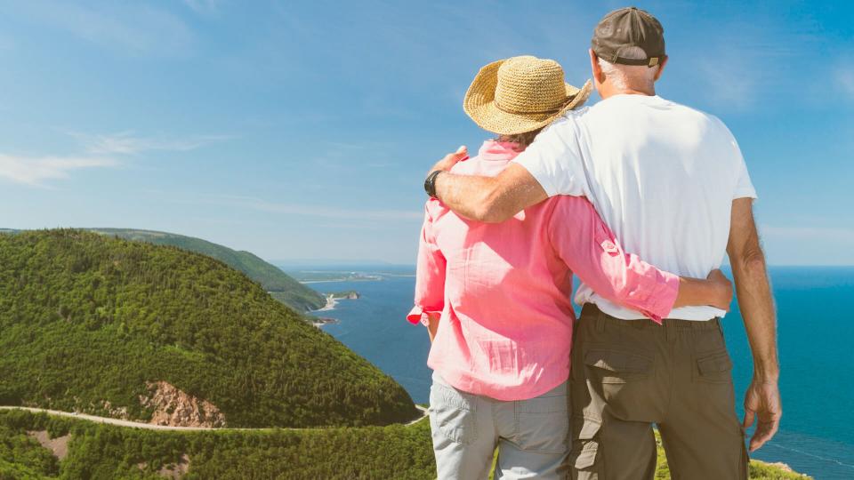 older couple taking in the view of a lake