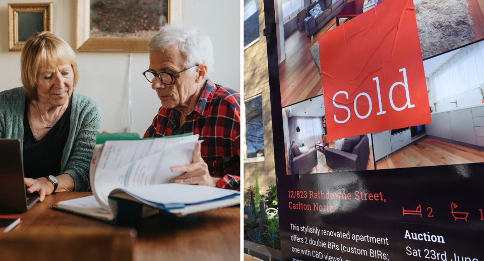 Older couple looking through finances next to Melbourne home for sale