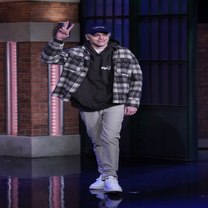 Pete waving to the crowd as walks onto the stage for a late-night talk show