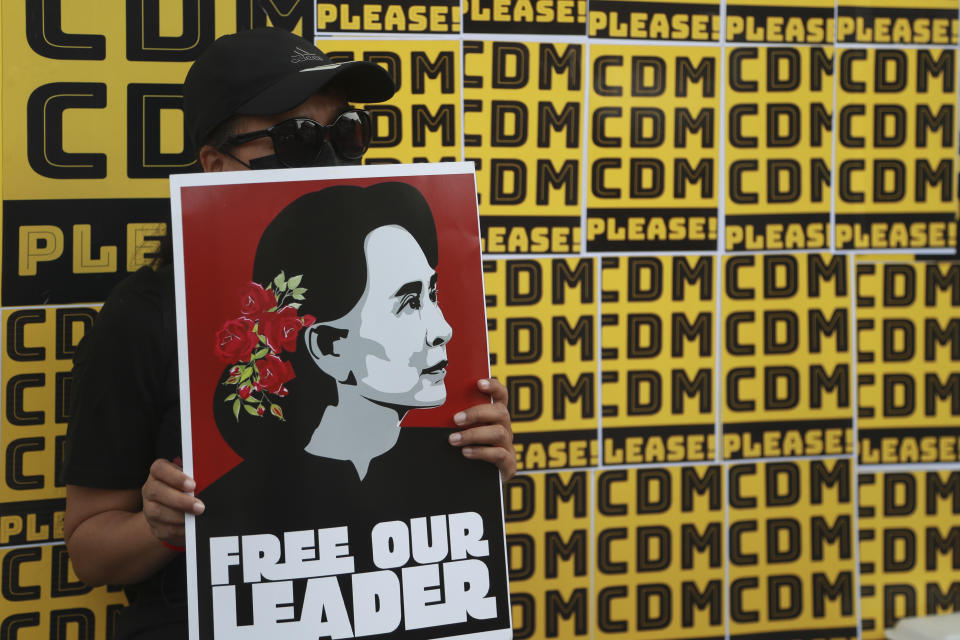 Protesters hold placards with images of ousted leader Aung San Suu Kyi during an anti-coup protest outside the Hledan Centre in Yangon, Myanmar, Sunday, Feb. 21, 2021. Police in Myanmar shot dead a few anti-coup protesters and injured several others on Saturday, as security forces increased pressure on popular revolt against the military takeover. (AP Photo)