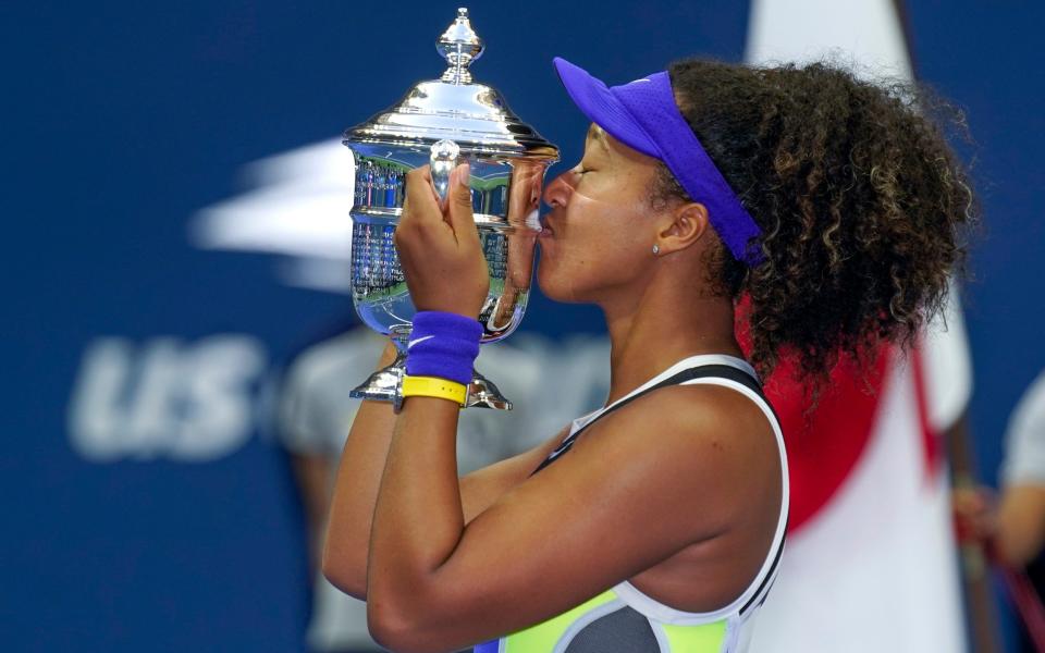 Naomi Osaka, of Japan, holds up the championship trophy after defeating Victoria Azarenka, of Belarus, in the women's singles final of the US Open tennis championships, Saturday, Sept. 12, 2020, in New York - AP/Seth Wenig 
