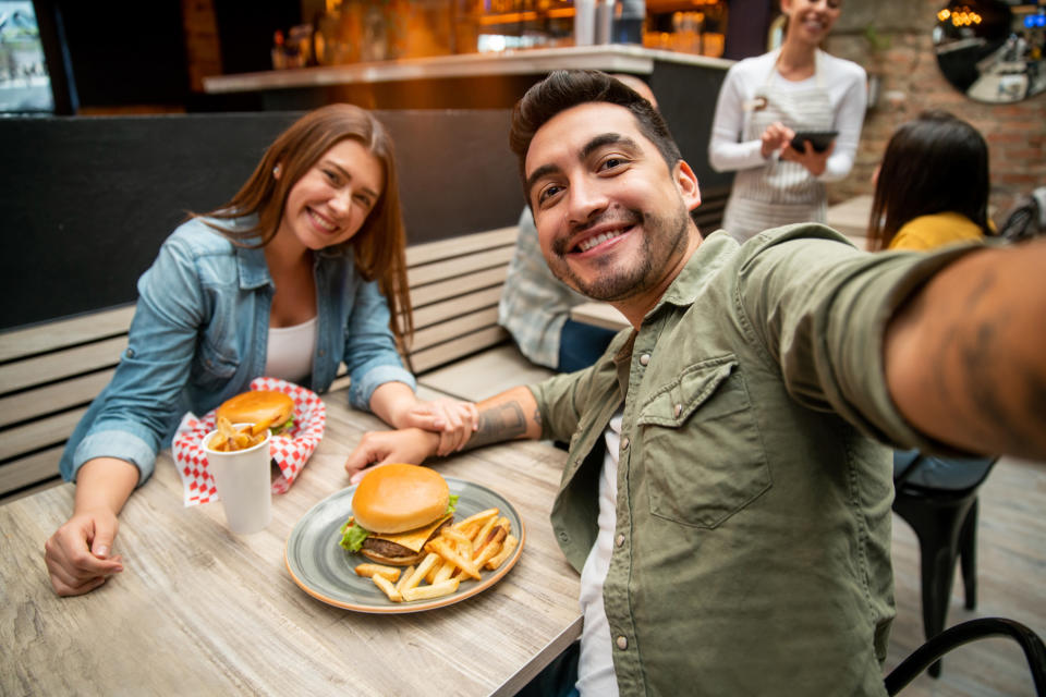 Couple taking a selfie together at a restaurant