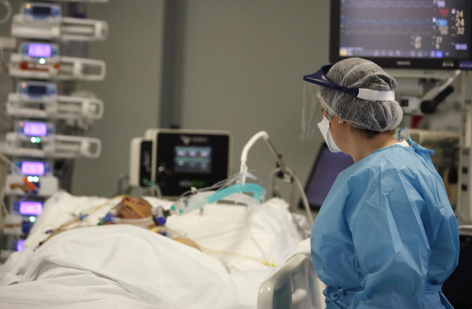 A medical staff member tends to a patient in the COVID-19 Intensive Care Unit of the Papa Giovanni XIII hospital in Bergamo, Italy, Thursday, March 18, 2021. Bergamo’s state-of-the-art Pope John XXIII Hospital verged on collapse last March: as army trucks ferried virus dead from the city’s over-taxed crematoria, doctors struggled to care for 600 COVID patients, 100 in intensive care. One year later, the picture is much improved: the hospital now is treating fewer than 200 virus patients, just one quarter of those requiring intensive care. (AP Photo/Antonio Calanni)