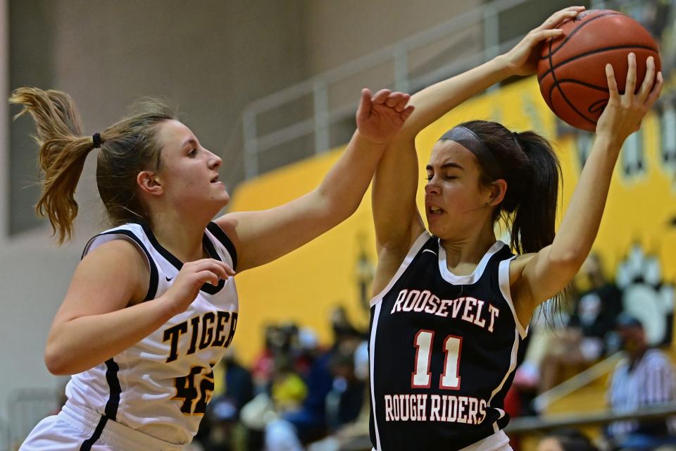 Roosevelt's Maya Sheller protects the ball from Cuyahoga Falls' Laila Smith during the first half of their game Wednesday night at Cuyahoga Falls High School.