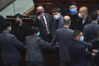 Pro-democracy lawmakers protest at the main chamber of the Legislative Council in Hong Kong, Thursday, June 4, 2020. Hong Kong’s legislature approved a contentious bill Thursday that makes it illegal to insult the Chinese national anthem. The legislation was approved after pro-democracy opposition lawmakers tried to disrupt the vote. (AP Photo/Vincent Yu)