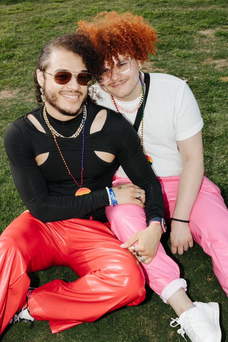 Two people embrace as they sit.