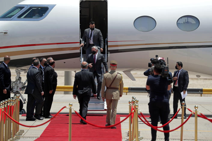 Jordan's King Abdullah II, center, arrives in Baghdad, Iraq, Sunday, June 27, 2021. (AP Photo/Khalid Mohammed)