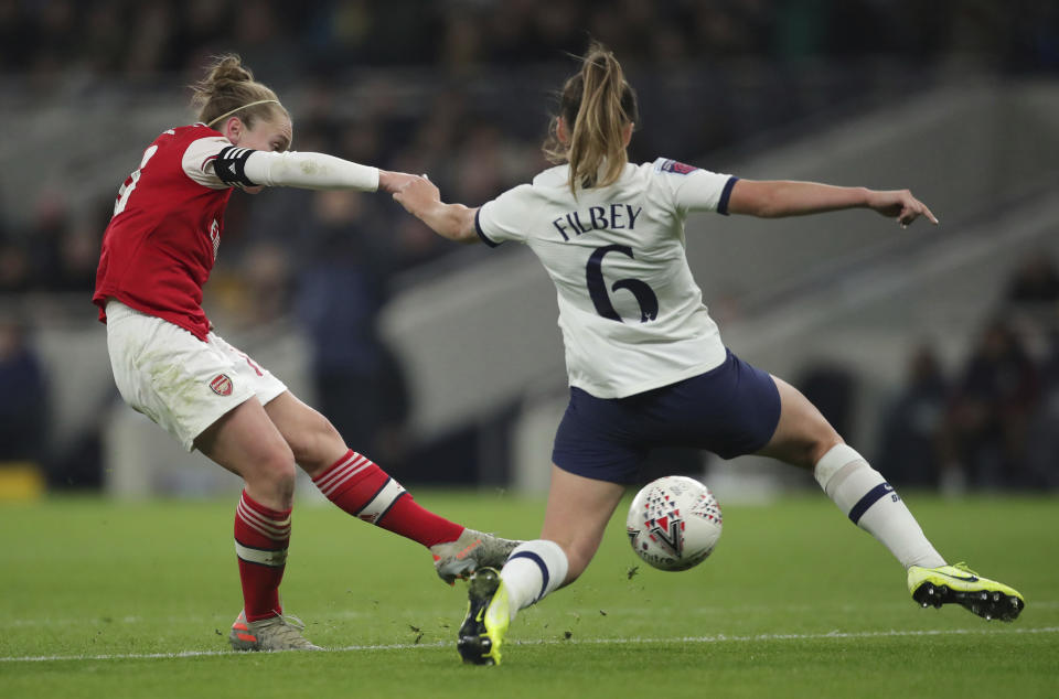 Arsenal's Kim Little, left, scores her sides first goal of the match against Tottenham Hotspur, during their Women's Super League soccer match at the Tottenham Hotspur Stadium in London, Sunday Nov. 17, 2019. The match drew a record crowd of 38,262 for the competition on Sunday when Arsenal claimed a 2-0 victory at Tottenham. (Zac Goodwin/PA via AP)