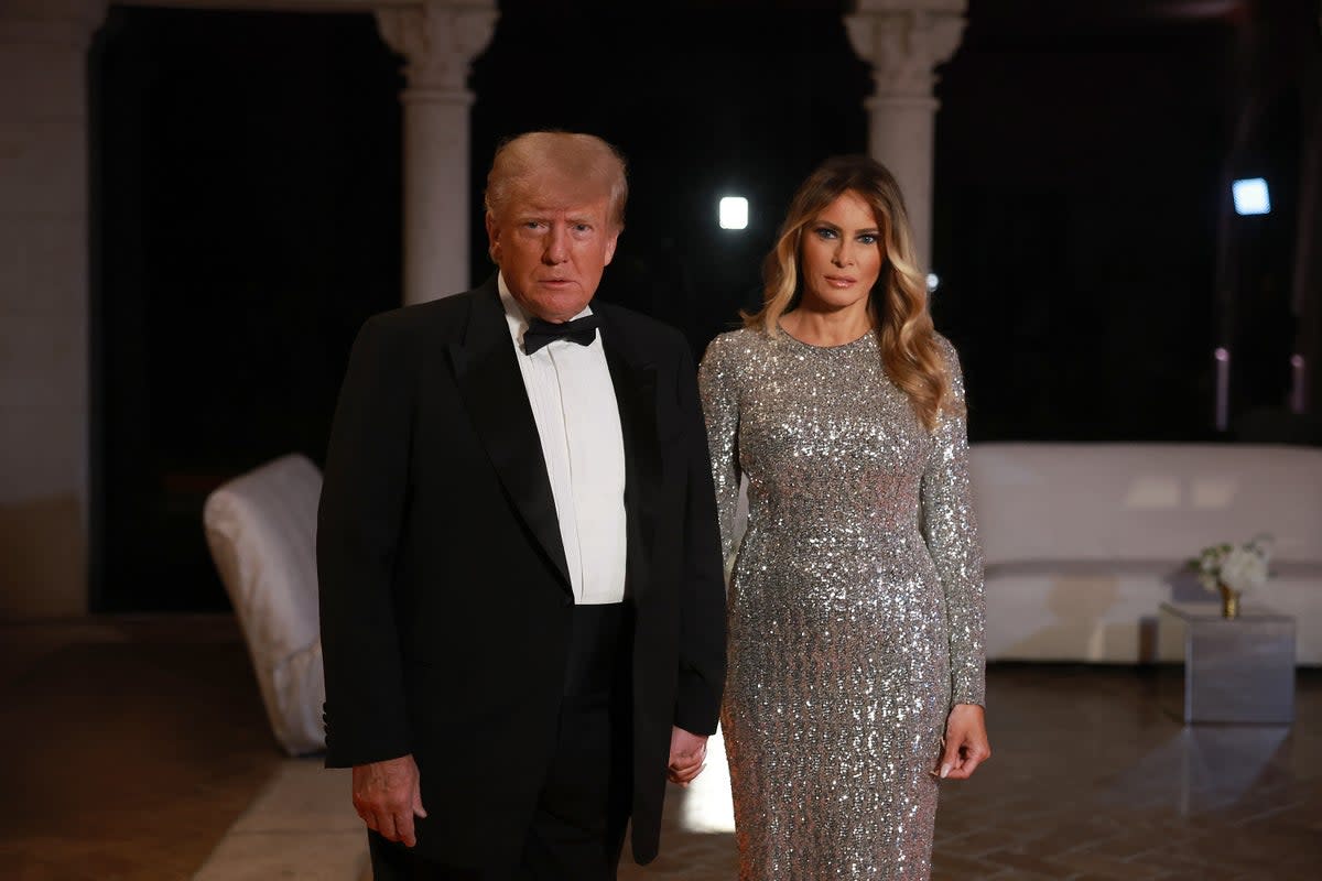 Former US President Donald Trump and former first lady Melania Trump arrive for a New Years event at his Mar-a-Lago home on December 31, 2022 in Palm Beach, Florida. (Getty Images)