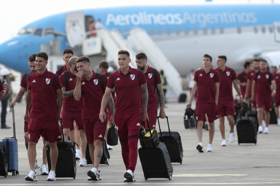 Argentina's River Plate soccer team walks on the airport tarmac after arriving to the military airport Grupo Aereo 8, in Lima, Peru, Wednesday, Nov. 20, 2019. The team will play Brazil's Flamengo on Saturday's Copa Libertadores final. (AP Photo/Martin Mejia)