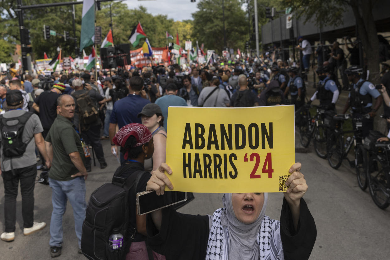 A protester holds a sign reading: Abandon Harris '24.