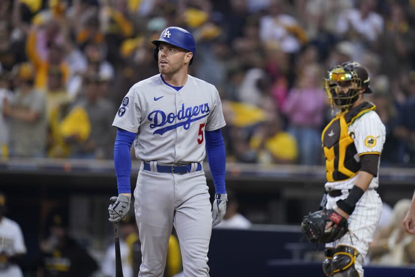 Los Angeles Dodgers' Freddie Freeman reacts after striking out during the first inning.