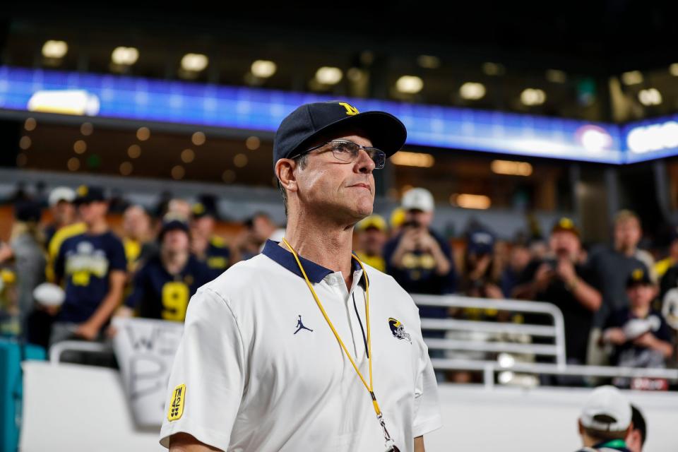 Michigan coach Jim Harbaugh takes the field for warmups before the Orange Bowl against Georgia on Friday, Dec. 31, 2021, in Miami Gardens, Florida.