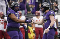 TCU quarterback Max Duggan (15) and offensive tackle Brandon Coleman (77) celebrate a touchdown during the first half of an NCAA college football game against Iowa State in Fort Worth, Texas, Saturday, Nov. 26, 2022. (AP Photo/LM Otero)