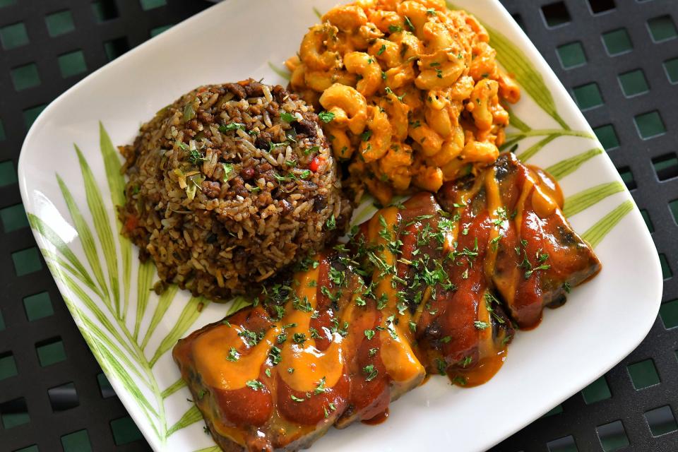 Kravegan's Smoked Kravyback Ribz, made with jackfruit and mushrooms with house-made sweet gold and smoky mesquite sauces. It is served with sides of Dirty Rice with a combination of Kravegan signature meatz alongside Mac N'Cheeze.