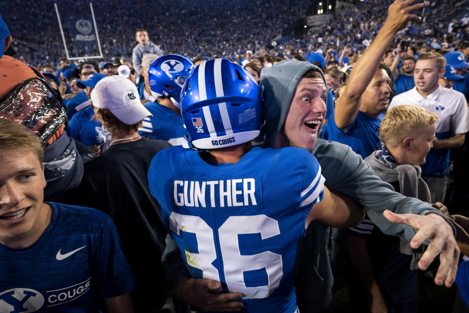 Sept. 10, 2022; Provo, Utah; Brigham Young Cougars wide receiver Talmage Gunther is embraced by a fan after the Cougars beat the Baylor Bears at LaVell Edwards Stadium. Gabriel Mayberry-USA TODAY Sports