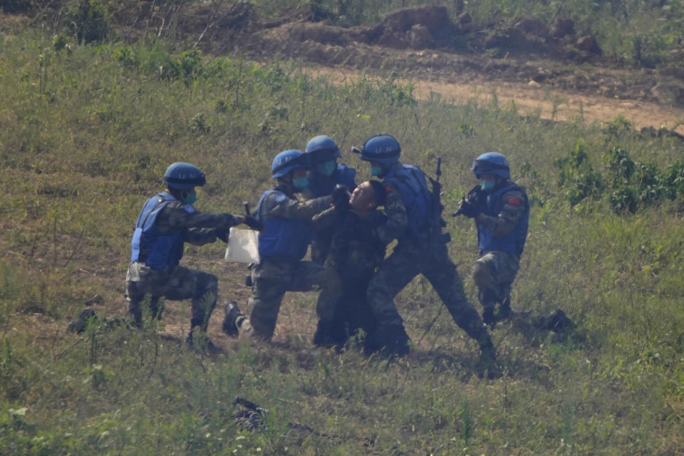 United Nations troops extract samples of a mock terrorist who surrendered after a failed attack on a United Nations base during the Shared Destiny 2021 drill at the Queshan Peacekeeping Operation training base in Queshan County in central China's Henan province Wednesday, Sept. 15, 2021. Peacekeeping troops from China, Thailand, Mongolia and Pakistan took part in the 10 days long exercise that field reconnaissance, armed escort, response to terrorist attacks, medical evacuation and epidemic control. (AP Photo/Ng Han Guan)