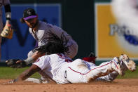 Colorado Rockies shortstop Brendan Rodgers, top, tags out Washington Nationals Josh Bell at second base during the eighth inning of a baseball game at Nationals Park, Sunday, Sept. 19, 2021, in Washington. (AP Photo/Andrew Harnik)
