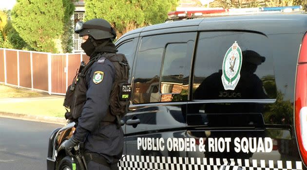 Two men have been arrested and police have seized a flag, machete and a hunting knife in anti-terror raids in Sydney on Wednesday. It's alleged the pair was planning to carry out an attack. Photo: AAP