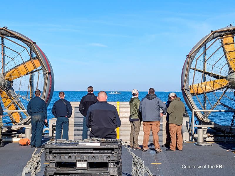 FILE PHOTO: FBI agents process the remains of a balloon shot down by U.S. military off South Carolina