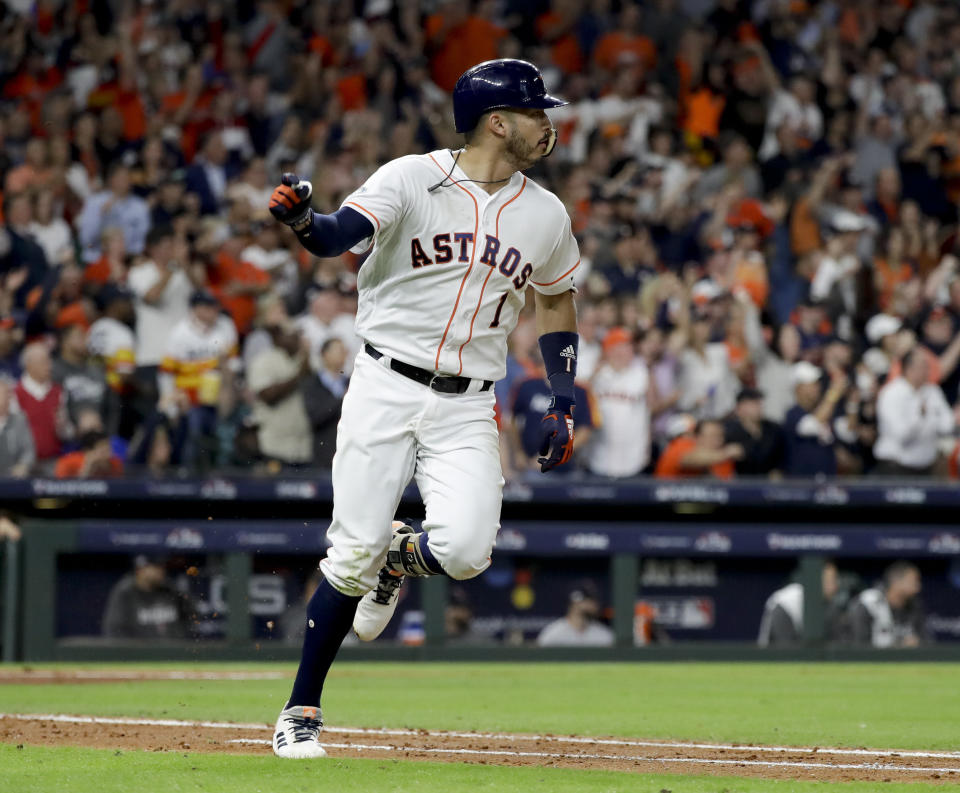 Houston Astros' Carlos Correa celebrates his RBI-single against the Boston Red Sox during the fifth inning in Game 4 of a baseball American League Championship Series on Wednesday, Oct. 17, 2018, in Houston.(AP Photo/David J. Phillip)