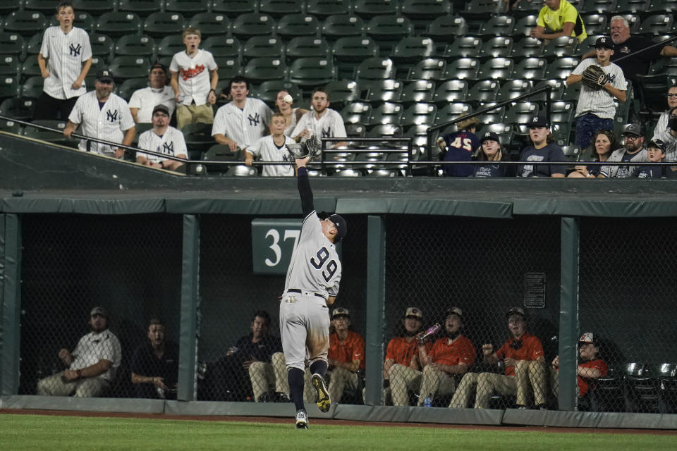 New York Yankees right fielder Aaron Judge (99) reaches to make a catch on a line drive hit by Baltimore Orioles' Anthony Santander during the eighth inning of a baseball game, Tuesday, Sept. 14, 2021, in Baltimore. (AP Photo/Julio Cortez)