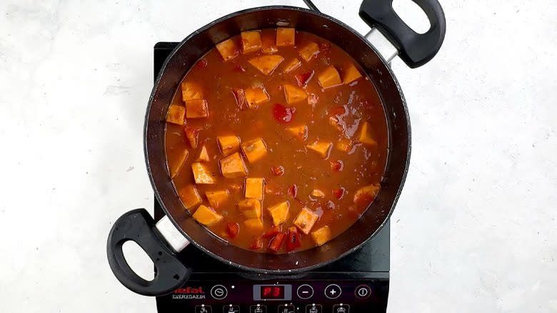 tomatoes and vegetable stock in pan