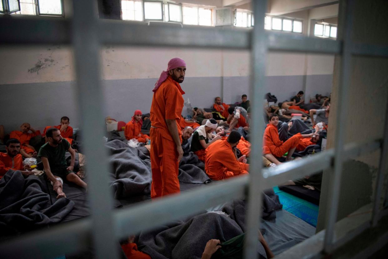 Men allegedly affiliated with Isis sit on the floor in a prison in the northeastern Syrian city of Hassakeh: AFP