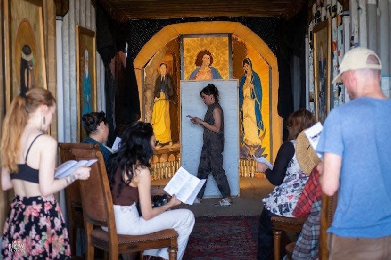 Jackie DesForges performs the first mass of the Church of Potential Life to an audience at the Bombay Beach Biennale.