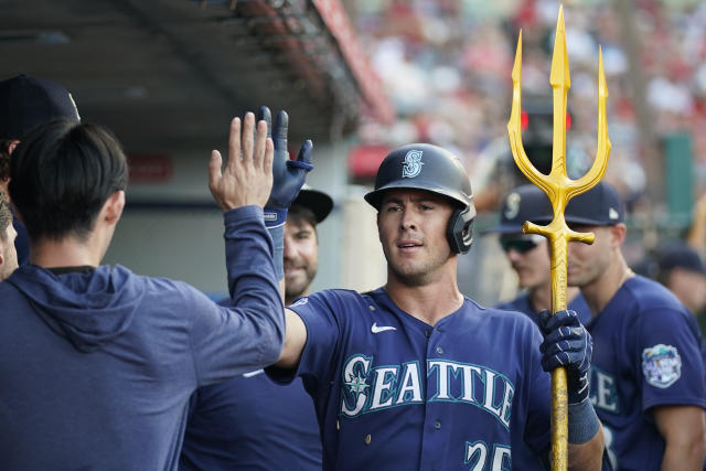 Seattle Mariners' Eugenio Suarez holds a trident as he celebrates