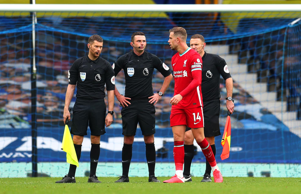 Liverpool captain Jordan Henderson speaks with officials after his apparent game-winning goal was ruled out. (Catherine Ivill/Getty Images)