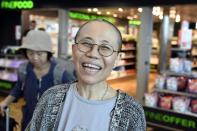 Liu Xia, the widow of Chinese Nobel dissident Liu Xiaobo, smiles as she arrives at the Helsinki International Airport in Vantaa, Finland