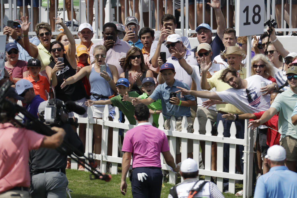 Fans cheer for Rory McIlroy, of Northern Ireland, as he leaves the 18th green during the third round of the World Golf Championships-FedEx St. Jude Invitational Saturday, July 27, 2019, in Memphis, Tenn. McIlroy birdied the 18th hole to finish the day at 12-under par, one stroke ahead of Brooks Kopeka. (AP Photo/Mark Humphrey)