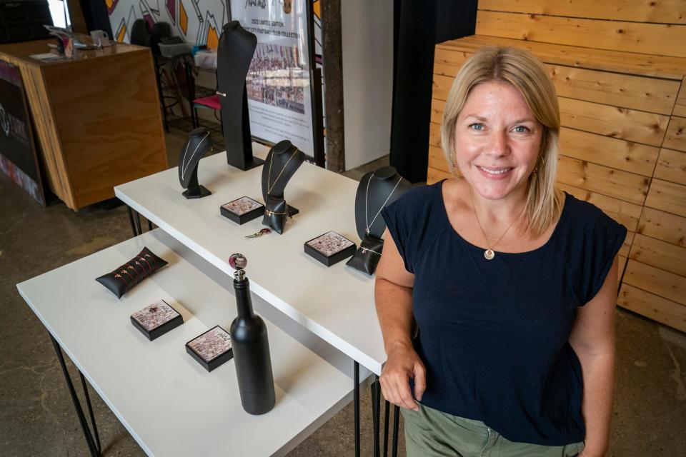 Rebel Nell founder Amy Peterson poses with a display of jewelry and other items that were created in a partnership with the Detroit City Football Club at her store on Holden Street in Detroit Monday, Aug. 22, 2022. Rebel Nell is a unique Detroit-based jewelry company that utilizes found flecks of graffiti to create one-of-a-kind pieces. The company's mission has created a path for underserved women to find employment and empowerment. Currently the company has partnered with the Detroit City Football Club to create jewelry and other pieces representing a mural that was created by fans.