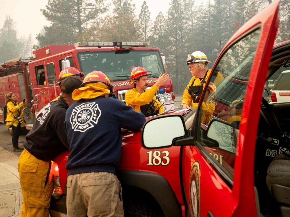 Firefighters plan their operations while battling the Camp Fire in Paradise, California (AP)