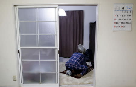 Abu Said Shekh, a 46-year-old asylum seeker from Bangladesh, prays at his house in Sakaimachi near Ota, Gunma prefecture, north of Tokyo, Japan, in this April 5, 2015 file photo. He was among 22 illegal immigrants, including an undisclosed number of asylum seekers, that were put on a state-chartered plane and flown back to Bangladesh on November 25, 2015, Japan's Justice Ministry said. REUTERS/Yuya Shino/Files