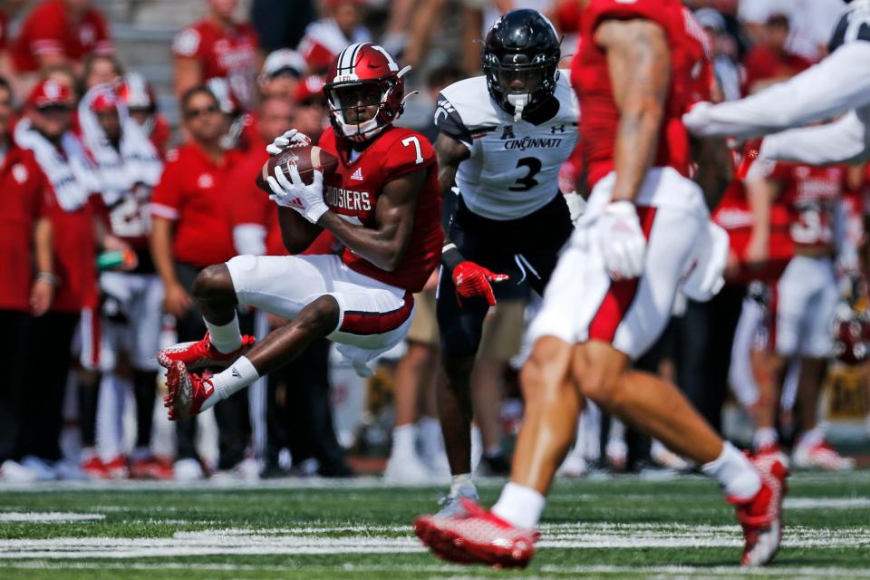 Indiana Hoosiers wide receiver D.J. Matthews Jr. (7) leaps to catch a pass under pressure from Cincinnati Bearcats safety Ja'von Hicks (3) in the second quarter of the NCAA football game between the Indiana Hoosiers and the Cincinnati Bearcats at Memorial Stadium in Bloomington, Ind., on Saturday, Sept. 18, 2021.