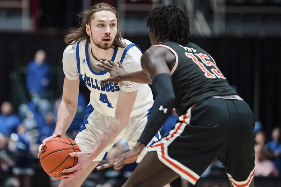 Campbell forward Jay Pal (15) guards North Carolina-Asheville forward Drew Pember (4) during the first half of the Big South Championship NCAA college basketball game on Sunday, March 5, 2023, in Charlotte, N.C. (AP Photo/Jacob Kupferman)