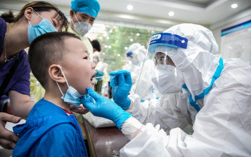 A child being given a nucleic acid test for the coronavirus in Nantong, in China's eastern Jiangsu province - STR/AFP via Getty Images