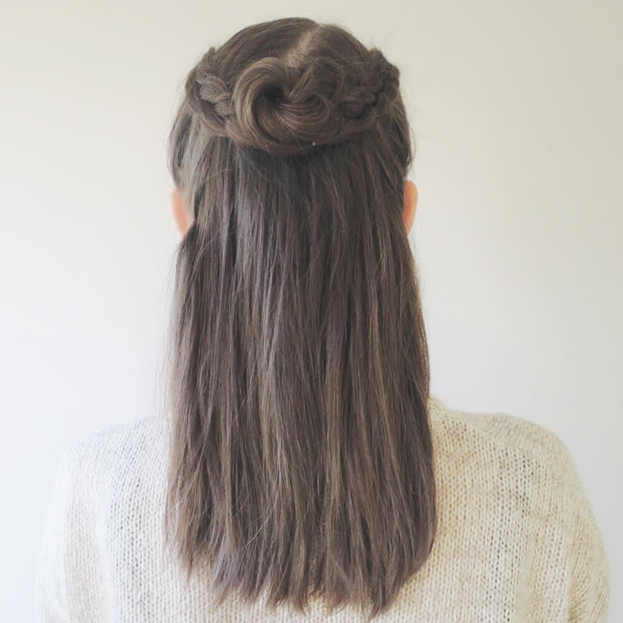 <p>Style the hair from the bottom of the braids into a messy bun, fixing in place with some hair ties. </p>