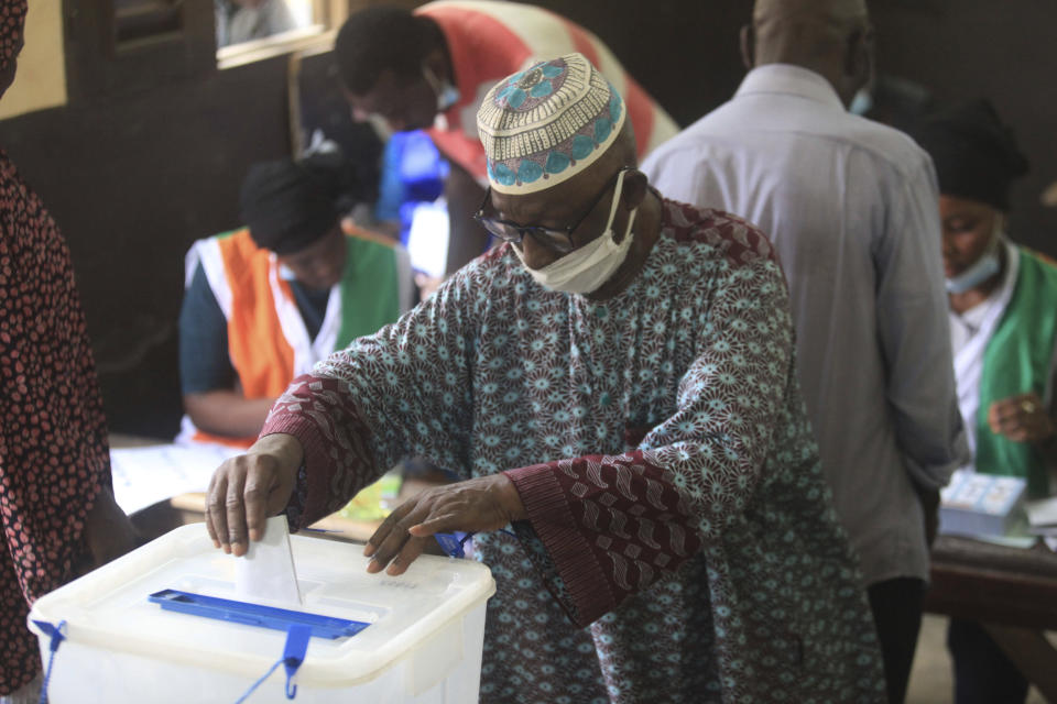 People cast their vote in presidential election in Abidjan, Ivory Coast, Saturday, Oct. 31, 2020. Tens of thousands of security forces deployed across Ivory Coast on Saturday as the leading opposition parties boycotted the election, calling President Alassane Ouattara's bid for a third term illegal. (AP Photo/Diomande Ble Blonde)