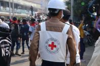 A member of Red Cross walks amid protests against the military coup in Dawei