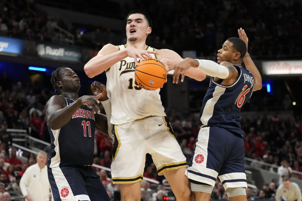 Purdue center Zach Edey (15) is fouled by Arizona forward Keshad Johnson (16) in the second half of an NCAA college basketball game in Indianapolis, Saturday, Dec. 16, 2023. (AP Photo/AJ Mast)