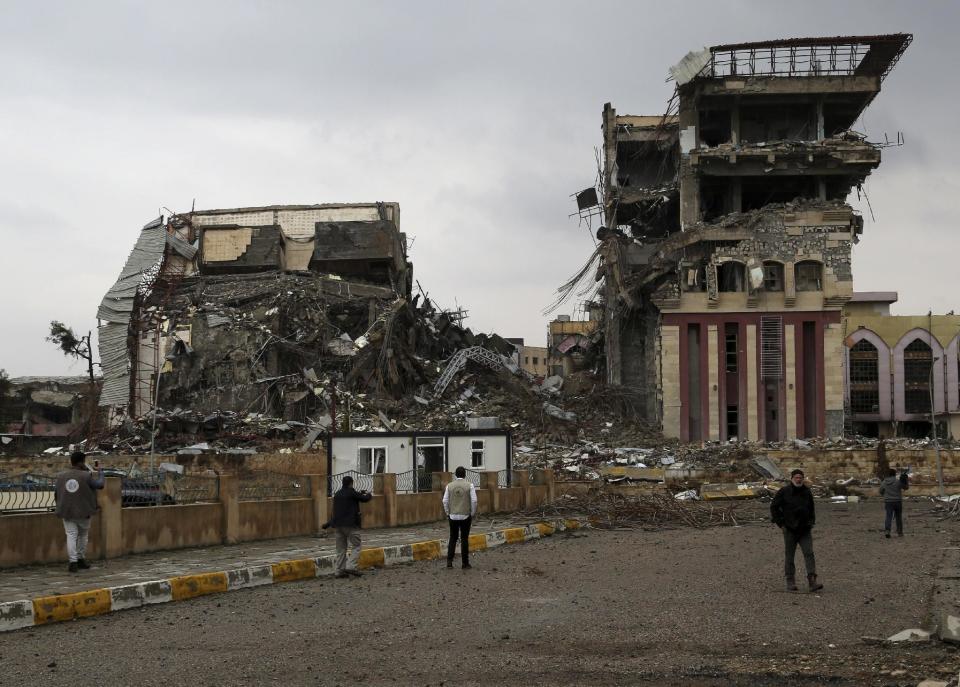 Students inspect their badly damaged university, recently liberated from Islamic State militants on the eastern side of Mosul, Iraq, Sunday, Jan. 22, 2017. (AP Photo/ Khalid Mohammed)