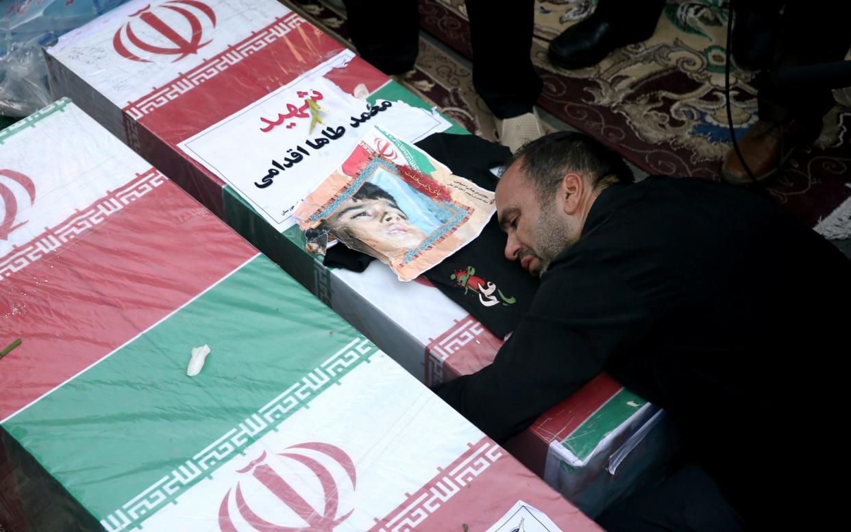 Father of Mohammad Taha Eghadami, a 4-year-old boy who was killed in Saturday's terror attack on a military parade, mourns over his coffin - AP